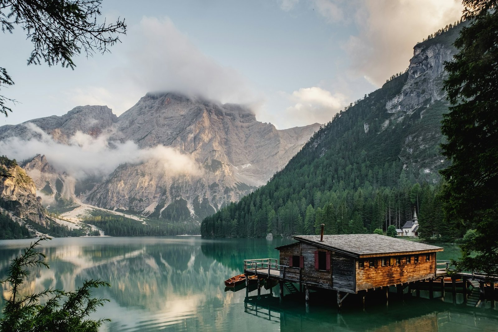 A lakeside cabin beneath mountain light